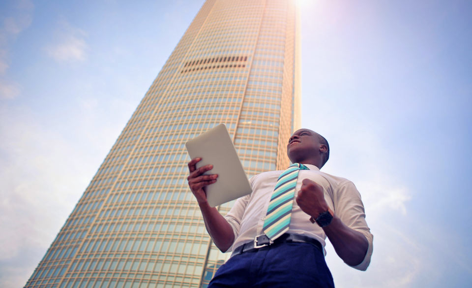 Man Standing outside Really Tall Building Man Standing outside Really Tall Building
