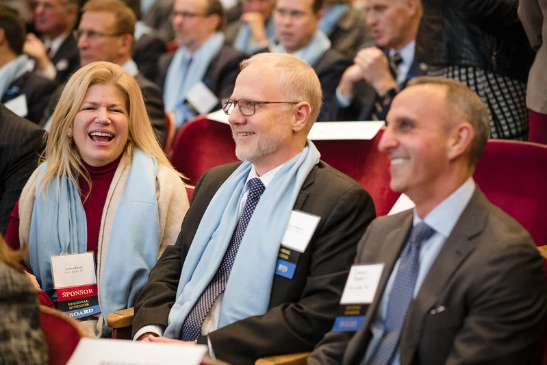 People seated and smiling